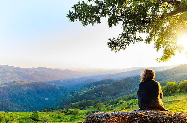 scenic view of woman watching at sunset mountains, Peneda-Geres National Park, northern Portugal.